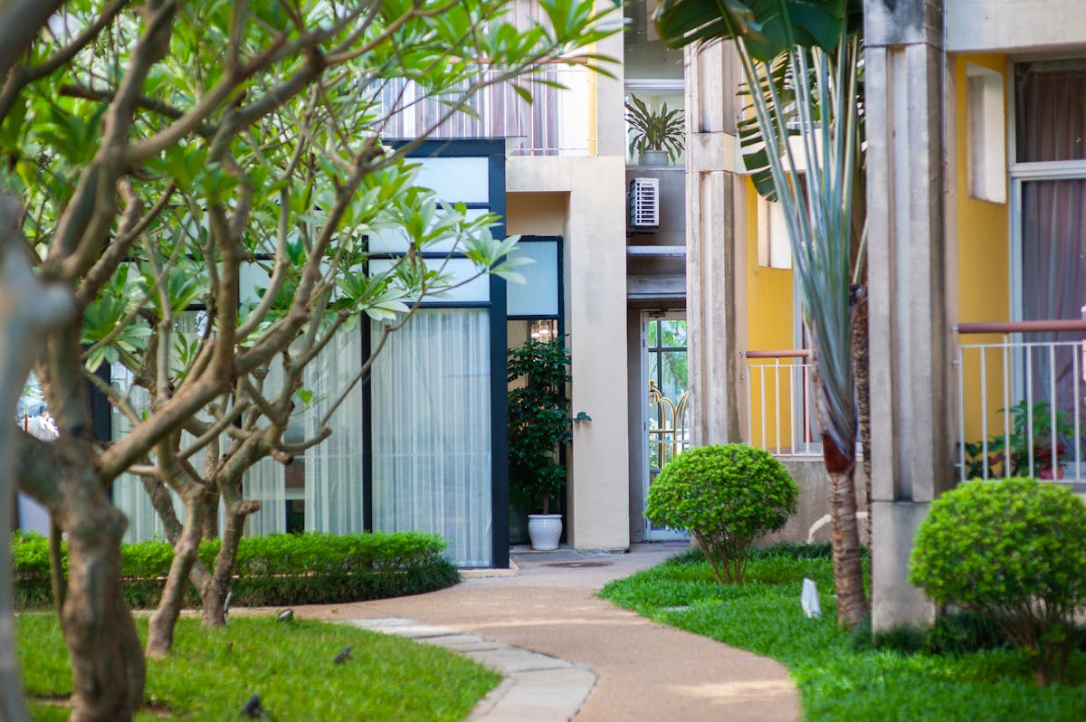 Quiet pathway in a residential setting, suggesting a gradual move forward.